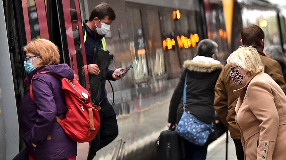 People make their way on and off a train at Stoke-on-Trent Train Station on 20 May 2021 in Stoke, England