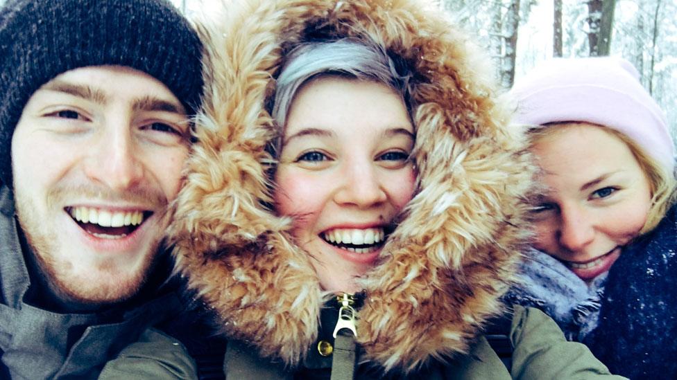 Three young adults taking a selfie photo in Finland