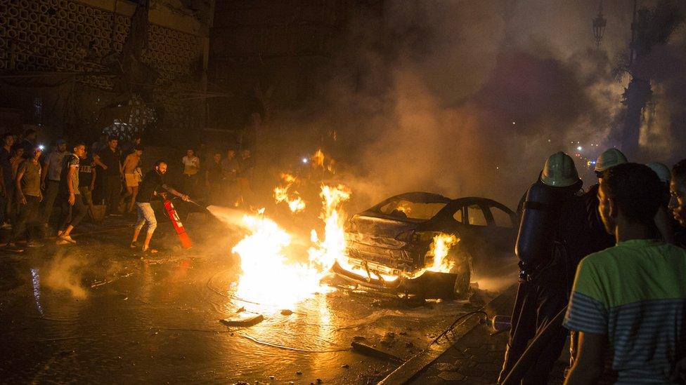 People extinguish a fire from a blast inside the National Cancer Institute,