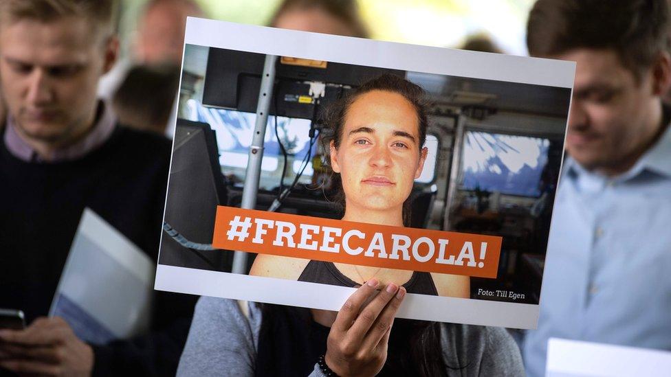 Demonstrators hold a banner reading "Free Carola" during a vigil in Cologne, western Germany, 2 July 2019