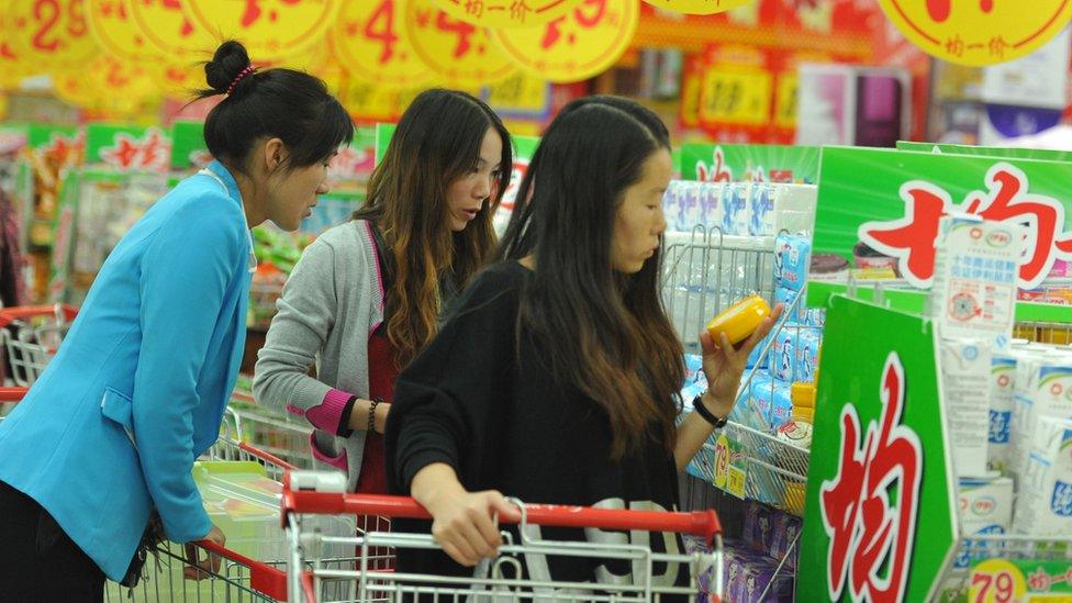 Customers browse goods in a supermarket in Fuyang, China