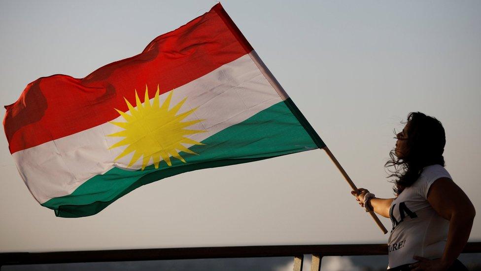 An Israeli Kurdish woman holds a Kurdish flag as she takes part in a rally outside the US embassy in Tel Aviv, Israel (26 October 2017)