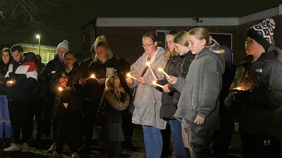 People holding candles