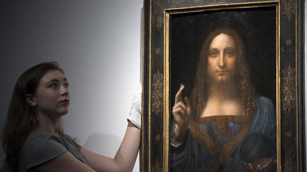 A Christie's staff member posed with Salvator Mundi before the auction