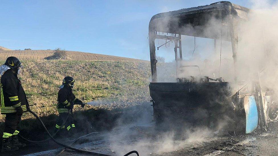 Firefighters at the scene of the bus fire