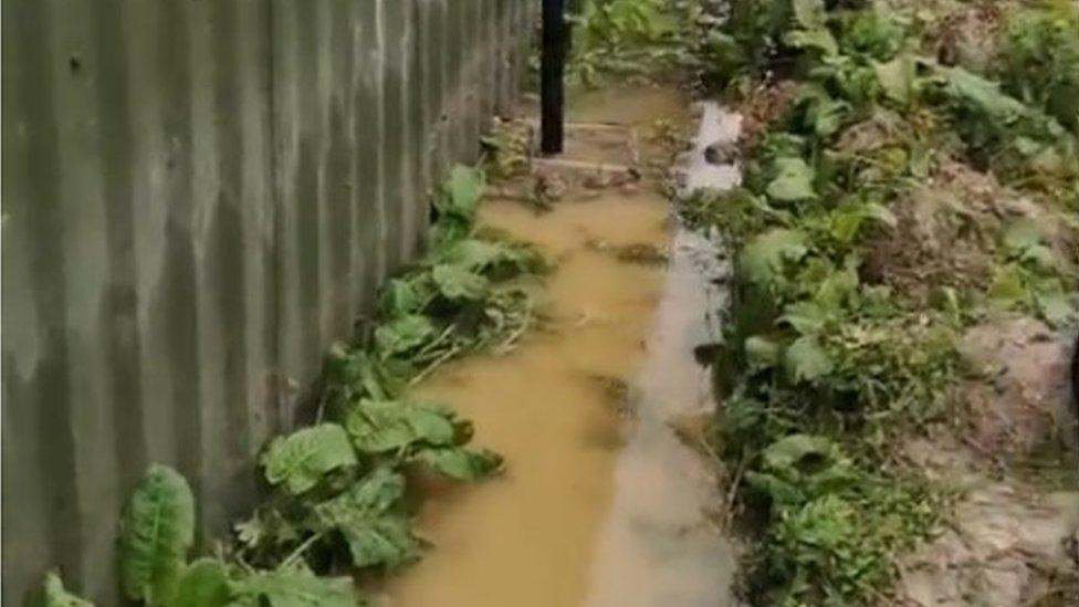 Flooded soakaway alongside animal hospital building