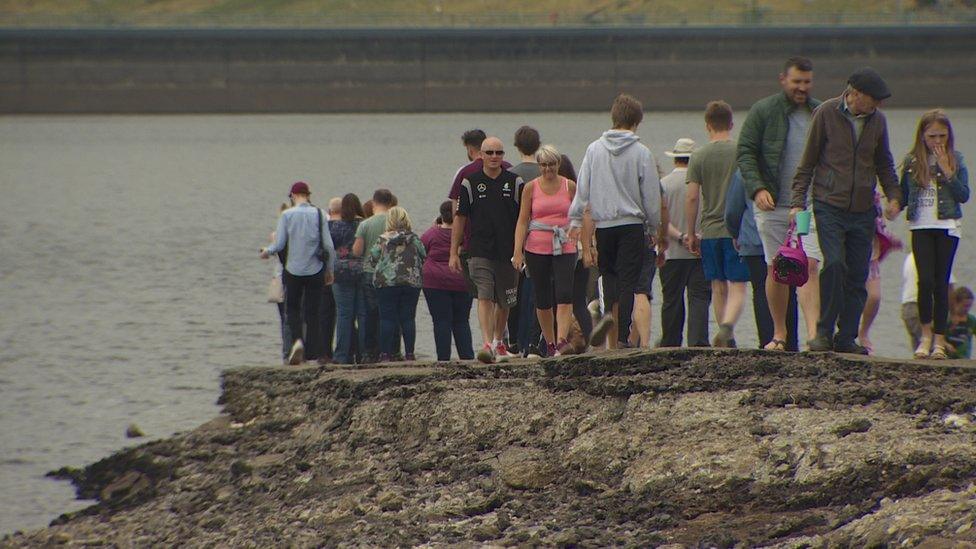 People walking along the old road at Spelga Reservoir