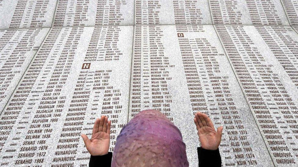 A Muslim woman prays near the list of victims of the Srebrenica massacre