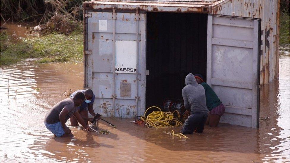 People looting a shipping container in Durban