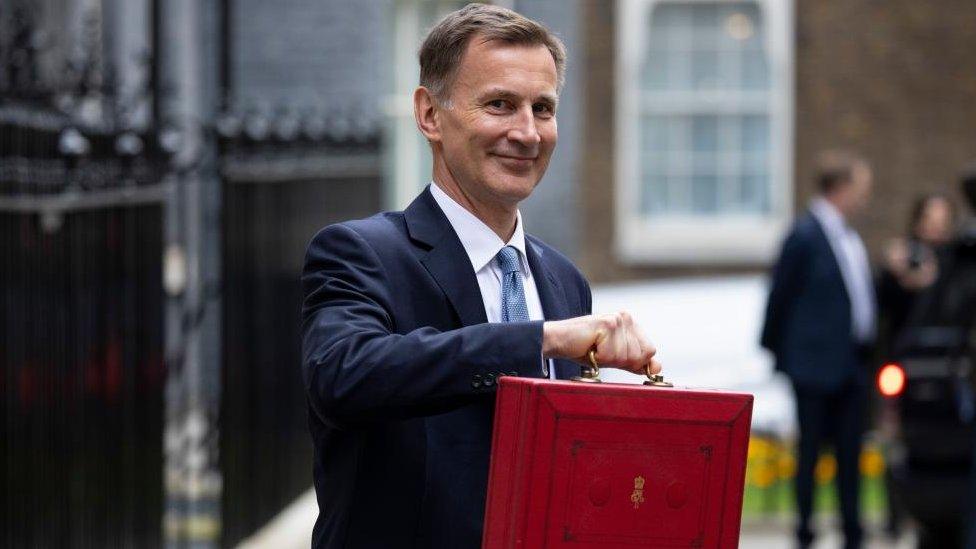 Jeremy Hunt holding a red brief case in Downing Street