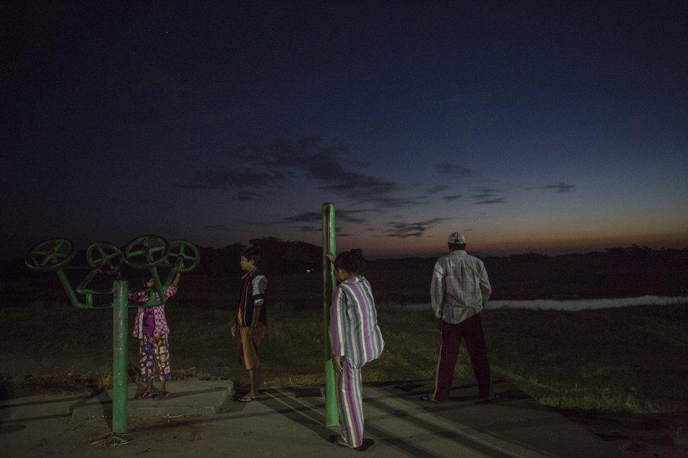 Residents of Hinthada, a town in Myanmar's Irrawaddy Delta, exercise just before dawn on November 4, 2015.