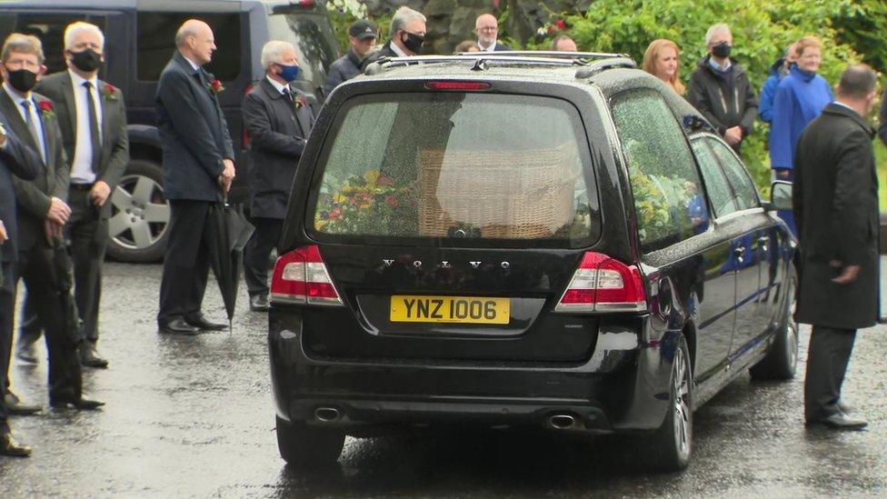 Mourners stood outside in the rain as John Hume's coffin was taken away to the city cemetery