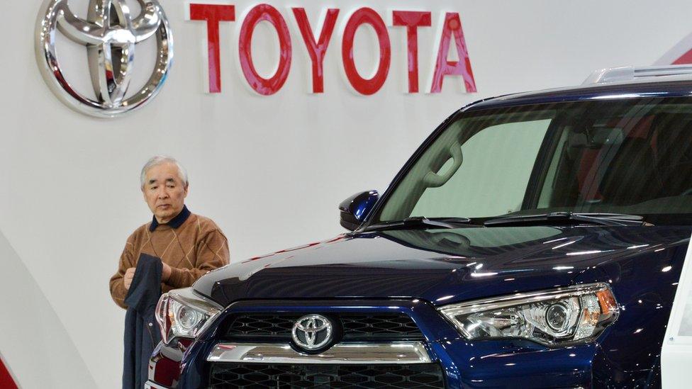 Man walking in Toyota showroom