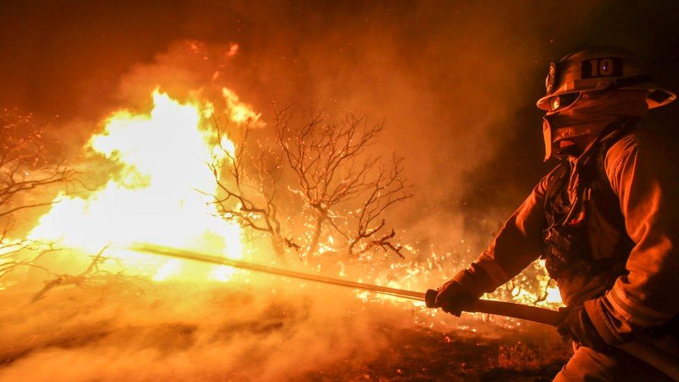 Firefighters working against the blaze