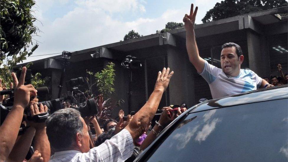 Guatemalan presidential candidate for the National Front Convergence Jimmy Morales greets supporters before voting in Mixco, near Guatemala City on 25 October, 2015