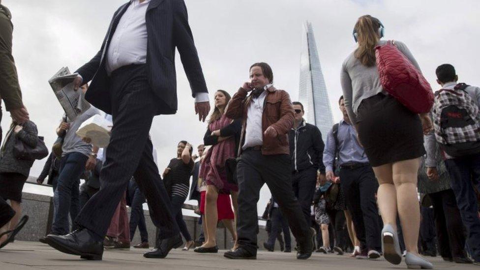 Commuters cross London Bridge in London, in this August 6, 2015 file picture.