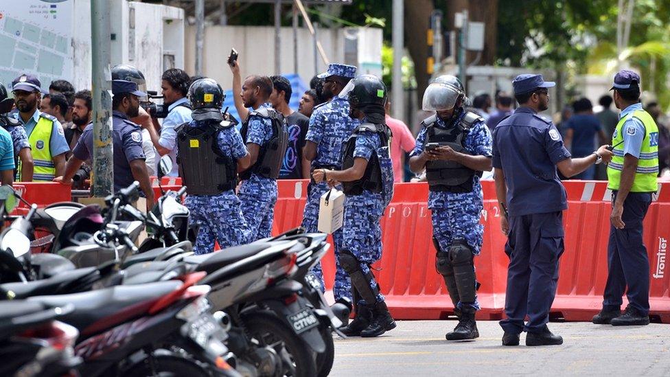 Maldives police patrol the streets of the capital Male.