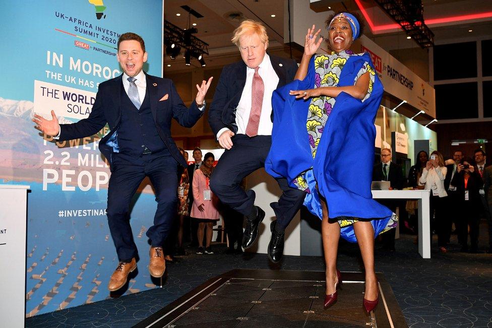 Prime Minister Boris Johnson visits the stand of a company that converts footsteps into energy, at the Innovation Zone during the UK-Africa Investment Summit in London