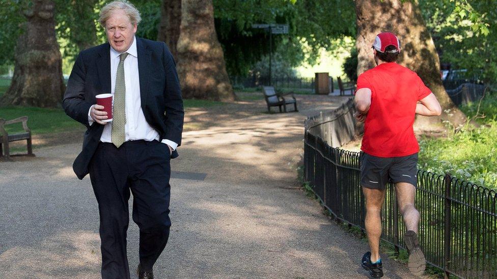 British Prime Minister Boris Johnson (L) walks through St James"s Park in central London, Britain, 06 May 2020. Britons are now in their sixth week of lockdown due to the ongoing coronavirus COVID-19 pandemic.