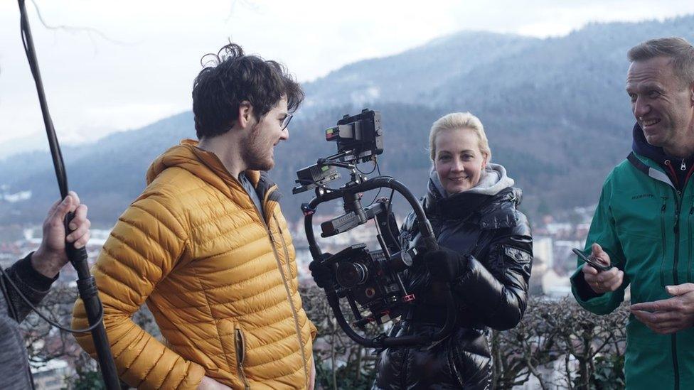 Daniel Roher, Yulia Navalnaya and Alexei Navalny on film set