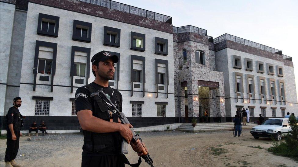 Pakistani policemen stand guard outside the hostel at Abdul Wali Khan university where students beat to death a classmate in Mardan on April 13, 2017.