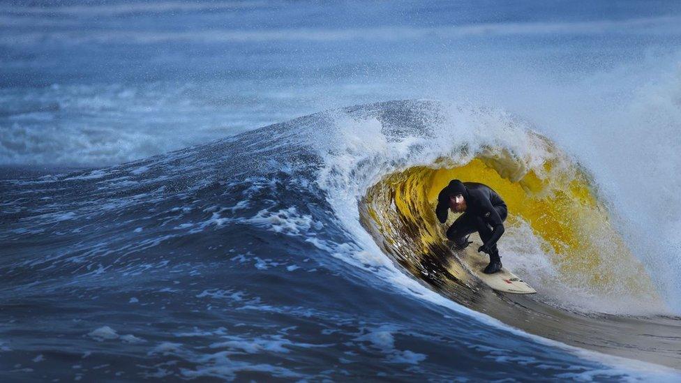 Al Mennie surfing at Portballintrae in the mouth of the River Bush