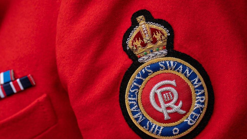 King Charles insignia on jacket of the King's Swan Marker