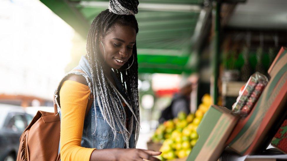 Woman buying something in a market