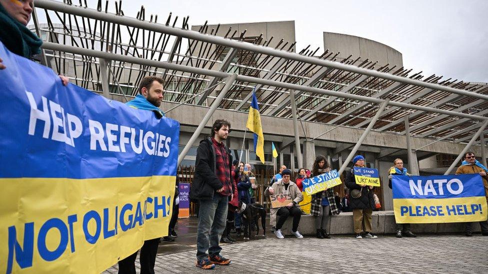 Members of the public show their support for Ukraine outside the Scottish Parliament on March 3, 2022 in Edinburgh