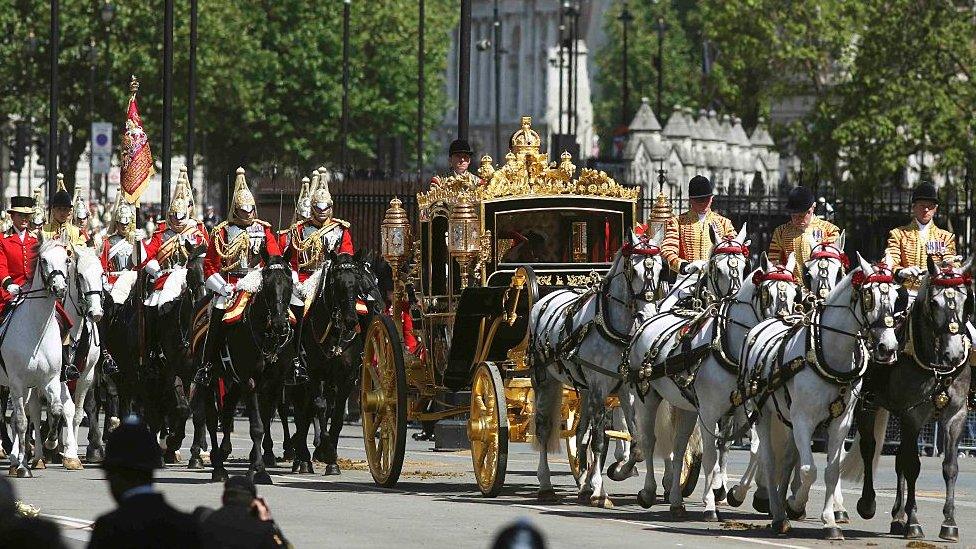 The Queen being driven by carriage during the State Opening of Parliament