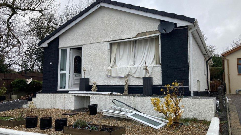 Bungalow house with front window blown out