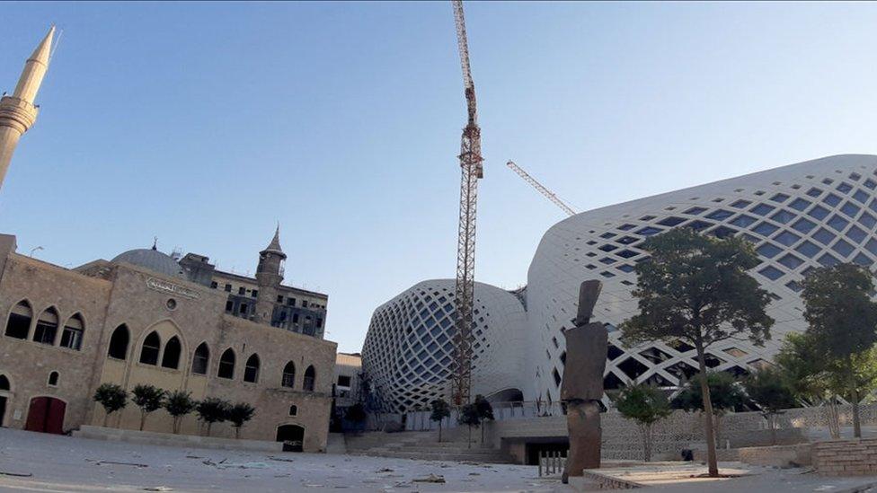 The façade a new Beirut commercial complex designed by the late British-Iraqi architect Zaha Hadid. On the left is the Lebanese capital's Majidiyah mosque. 5 August 2020