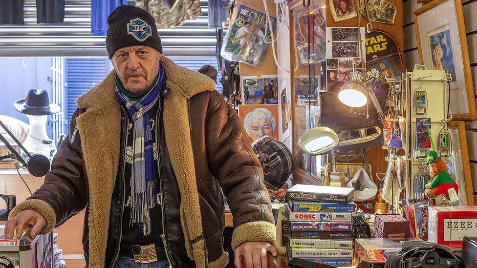 A vendor wearing a leather shearling jacket