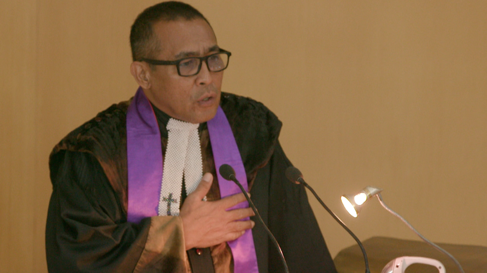 Jacky Manuputty pictured preaching at a church pulpit