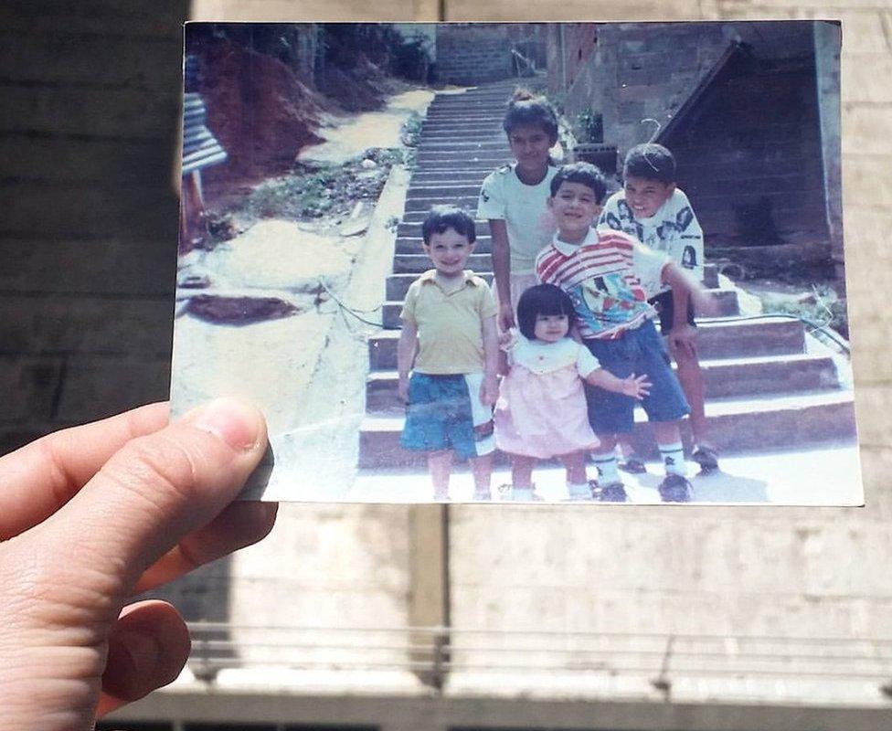 Jose holds a picture of his younger self with his cousins and a niece in Nino Jesus in the '90s