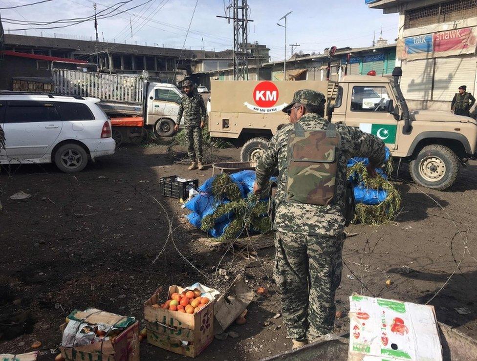 Pakistani security officials inspect the site of a bomb explosion at a vegetable market in Parachinar city, the capital of Kurram tribal district on the Afghan border on January 21, 2017.