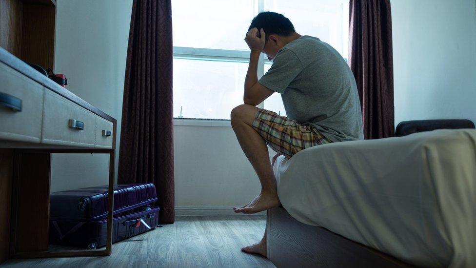 Worried man sits on sofa