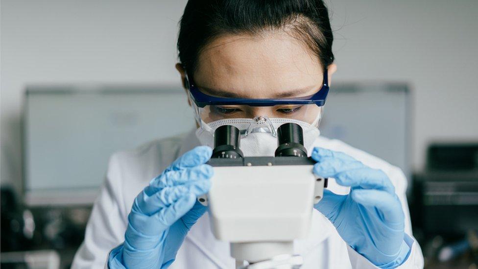 scientist with microscope