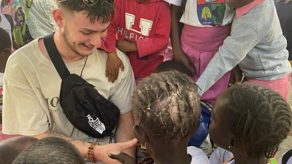 Mr Wollen with children in the village