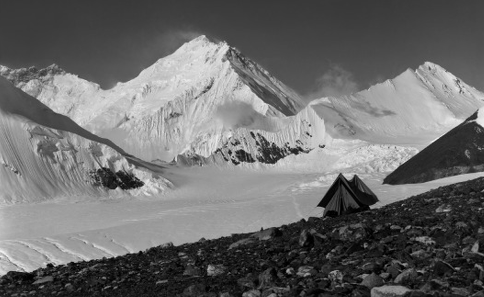 A snowy mountain shot including a small old-fashioned tent, captioned, "Camp at 20,000 feet - the last day"