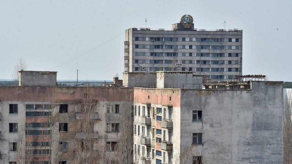 Soviet Union state emblem is set on a building of the ghost city of Pripyat near Chernobyl