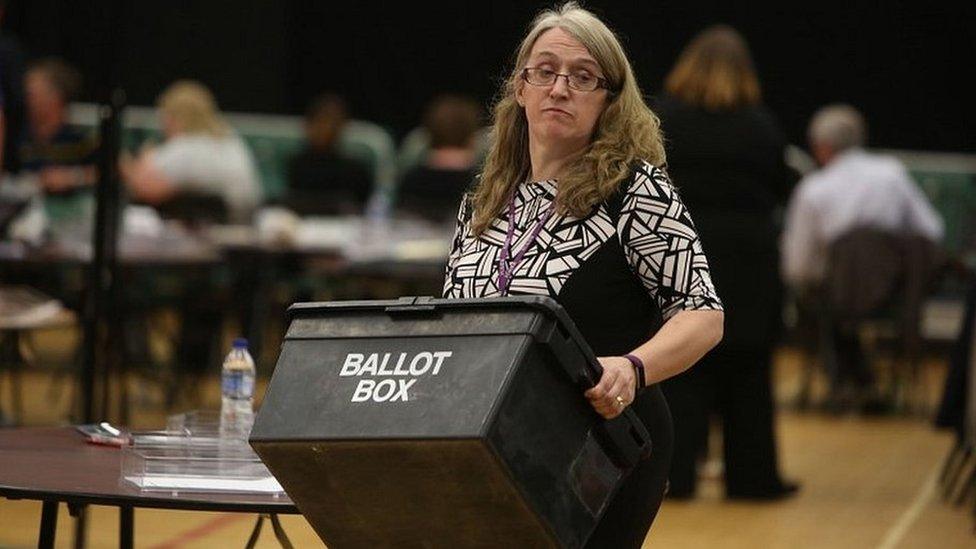 Woman carrying ballot box on the the night of the 2017 election