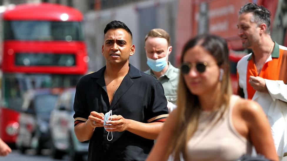 Pedestrians walk around the Oxford Street shopping district on 31 July 2021