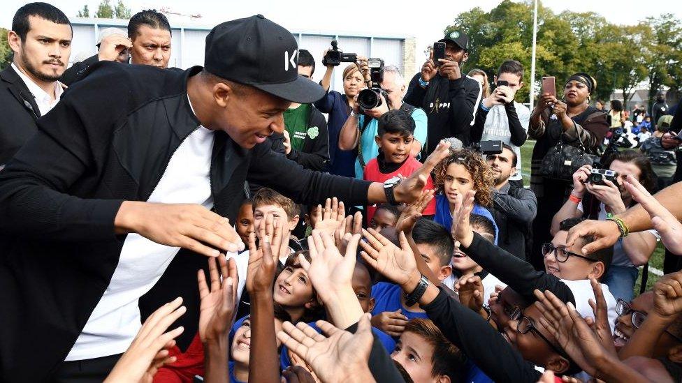 Mbappé meeting children in his home town of Bondy, France.