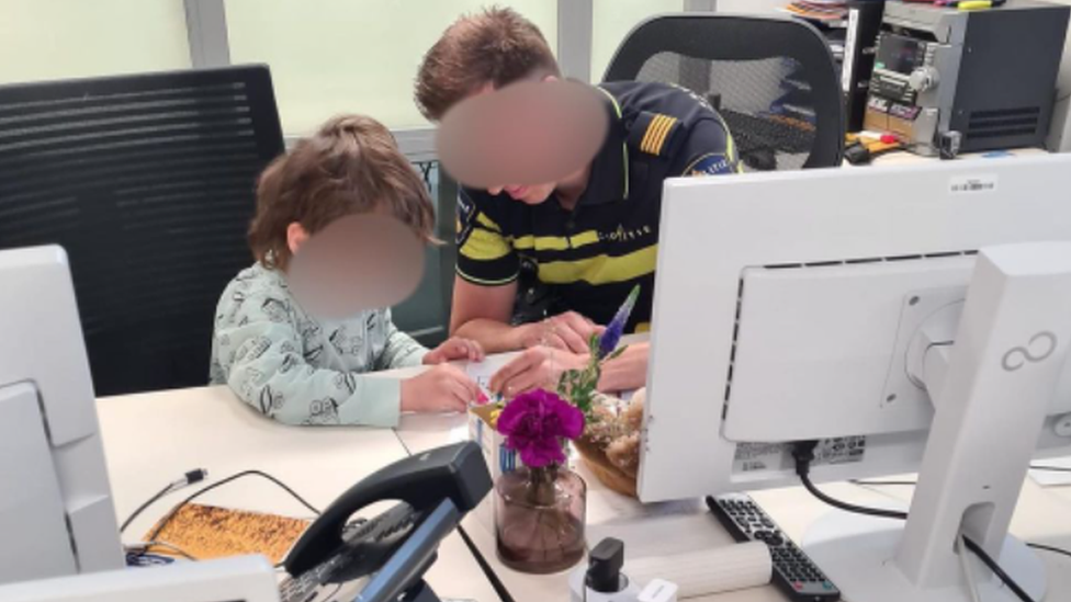 Police officer and boy at the police station