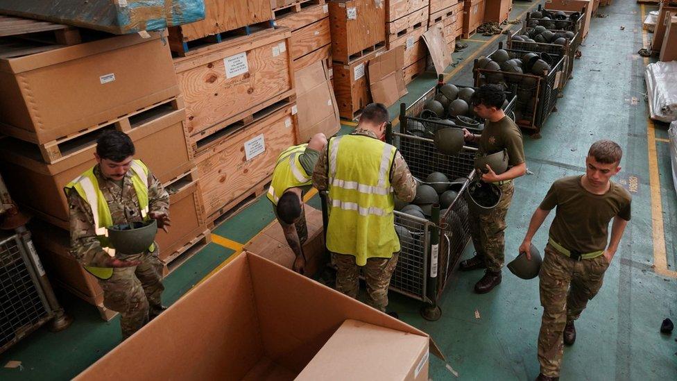 Soldiers sorting helmets