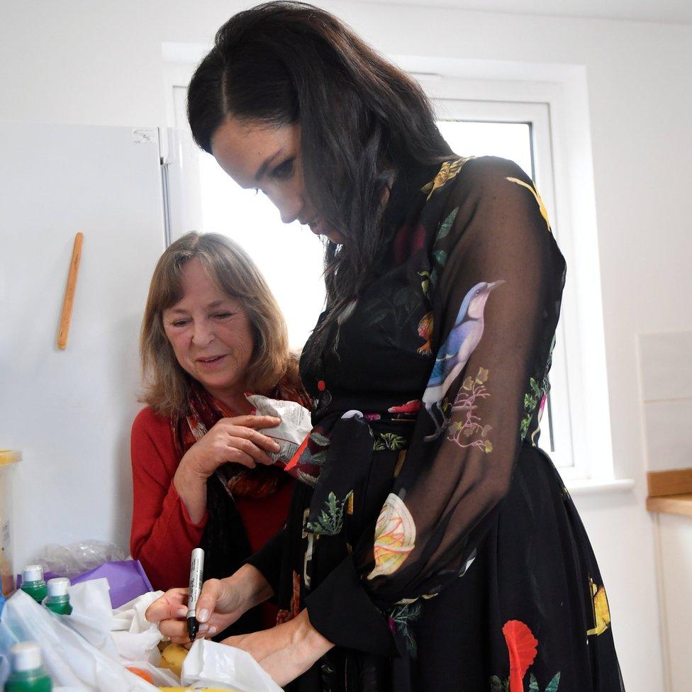 Meghan writing her messages on the fruit