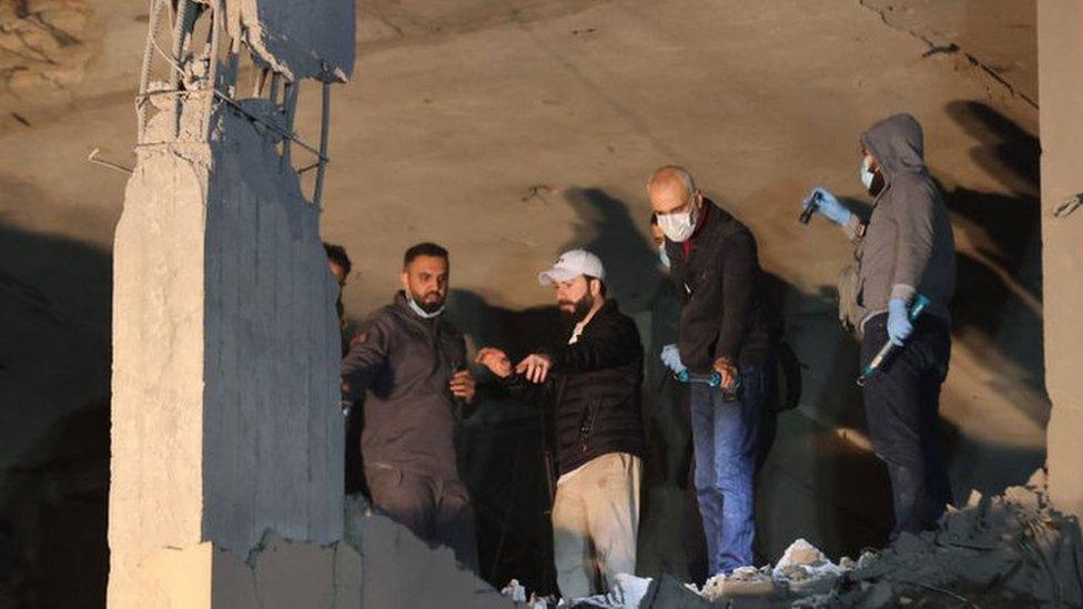 Lebanese emergency responders gather at the site of a strike, reported by Lebanese media to be an Israeli strike targeting a Hamas office, in the southern suburb of Beirut on January 2, 2024.