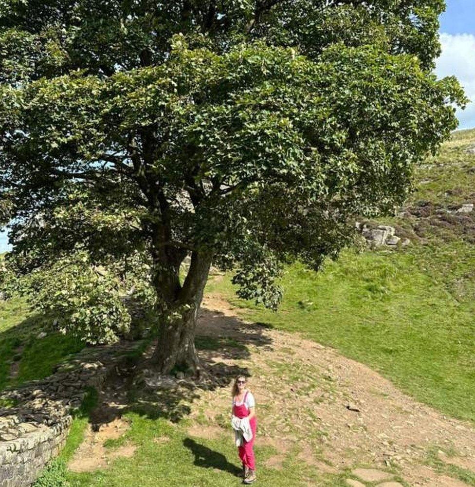 George's partner Tiggy Brearley in front of the Sycamore Gap tree in August