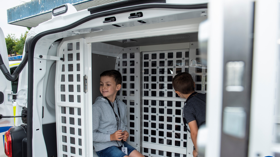 Oscar and Charlie in a police van